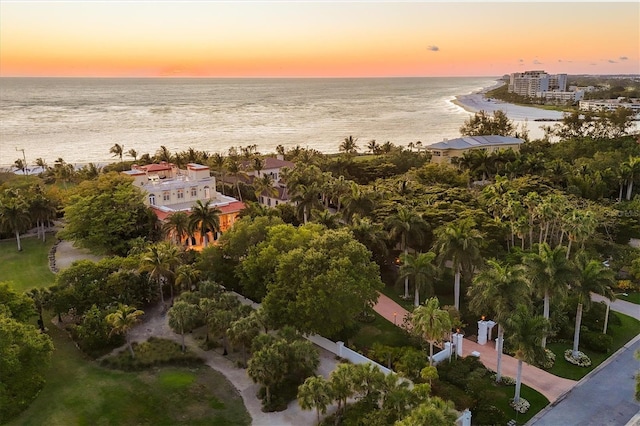 aerial view at dusk featuring a water view