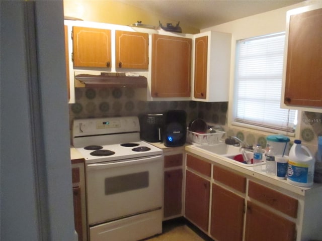 kitchen with sink, white electric range, and backsplash