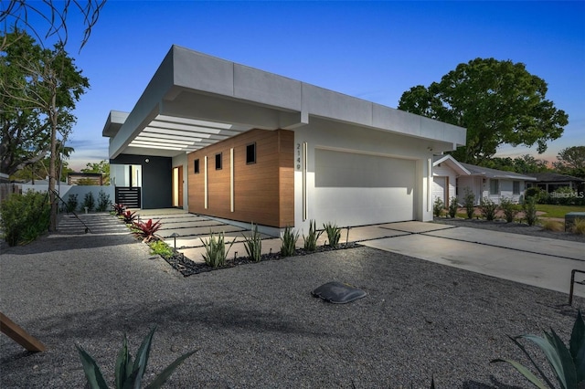 view of side of property with a garage and concrete driveway