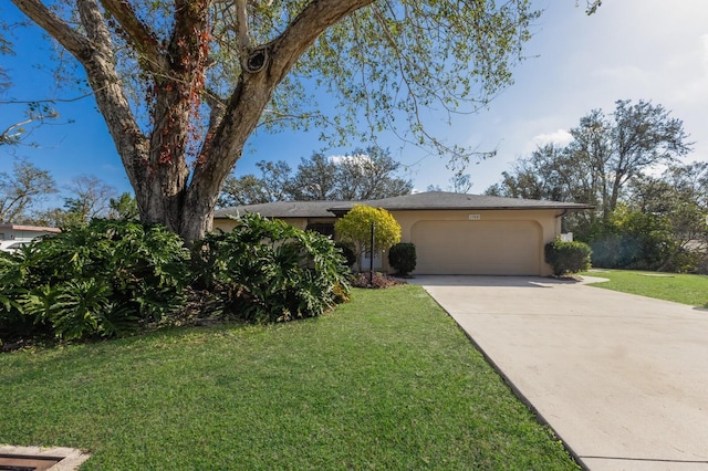 view of front of property featuring a garage, stucco siding, driveway, and a front yard