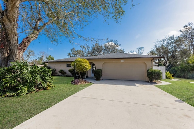 ranch-style home with a garage and a front lawn