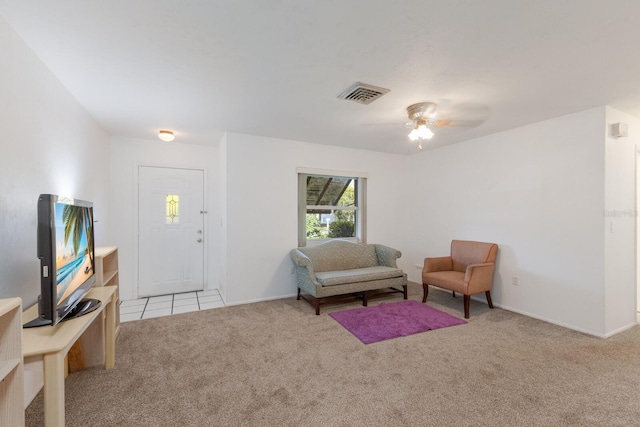 living area featuring a ceiling fan, carpet, visible vents, and baseboards