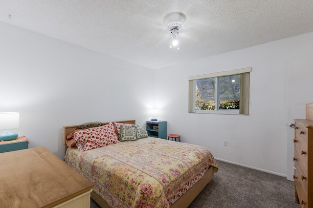 carpeted bedroom featuring baseboards and a textured ceiling