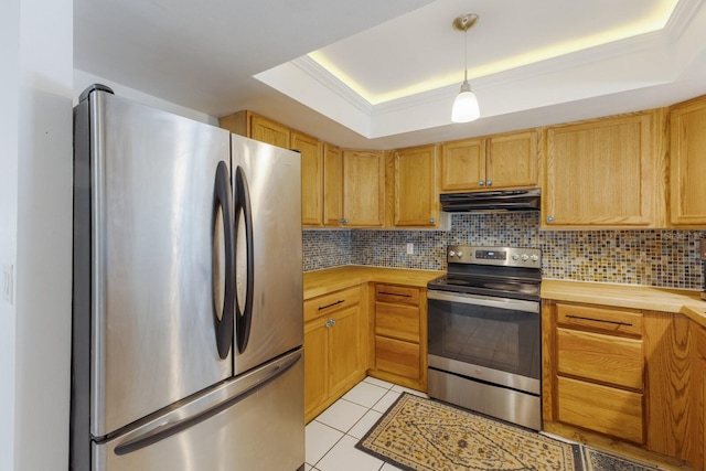 kitchen with stainless steel appliances, a raised ceiling, tasteful backsplash, and light tile patterned flooring