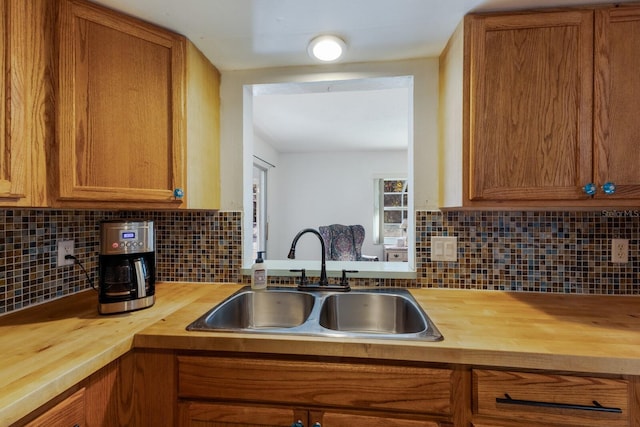 kitchen featuring butcher block counters, a sink, and brown cabinets