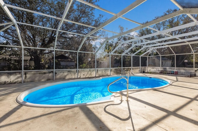 view of swimming pool with a patio and a lanai