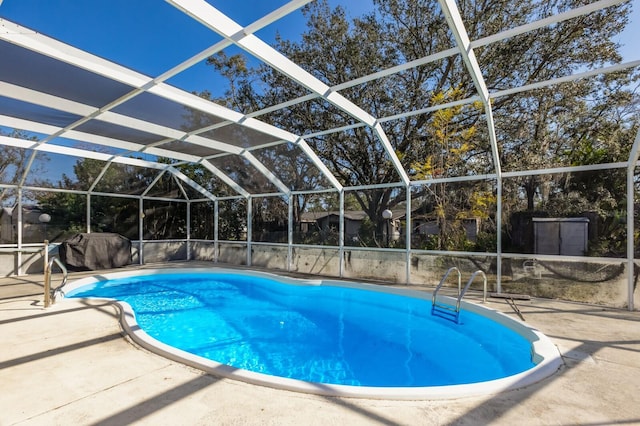 view of swimming pool featuring a lanai and a patio