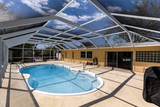 pool with a lanai and a patio area