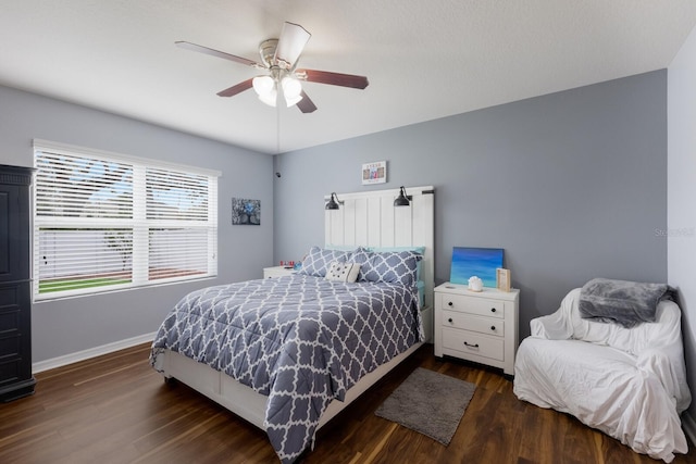 bedroom with dark wood-type flooring and ceiling fan