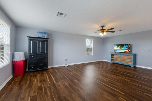 unfurnished bedroom with dark wood-type flooring and ceiling fan