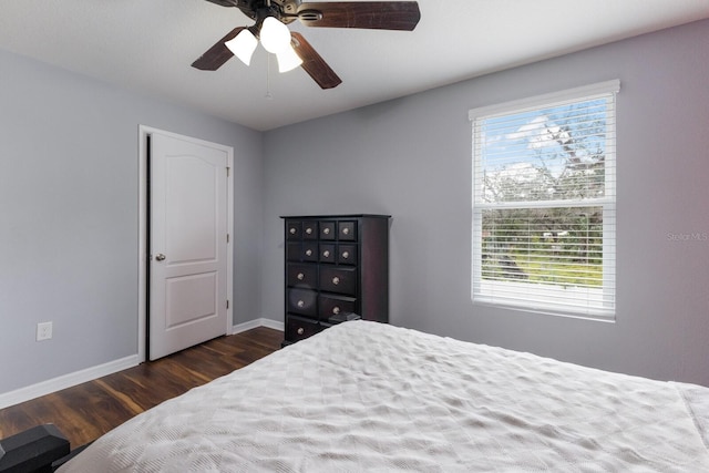 bedroom with ceiling fan and dark hardwood / wood-style floors