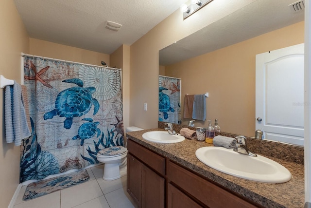 bathroom featuring tile patterned floors, vanity, toilet, and a textured ceiling