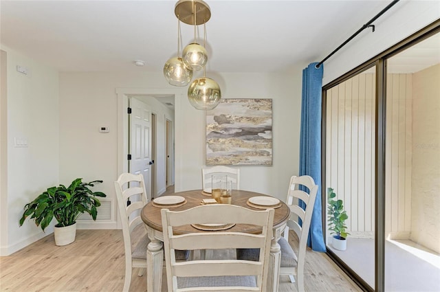 dining space featuring light wood-type flooring