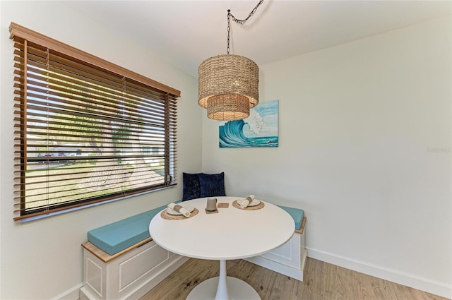 dining room with light hardwood / wood-style flooring and a chandelier