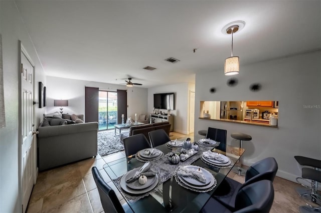 dining space with light tile patterned floors and ceiling fan