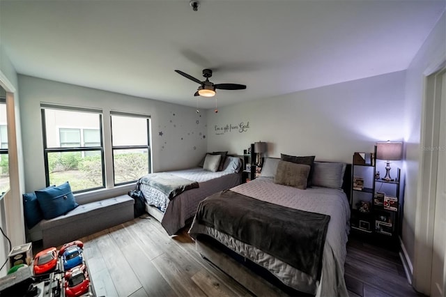 bedroom with hardwood / wood-style floors and ceiling fan