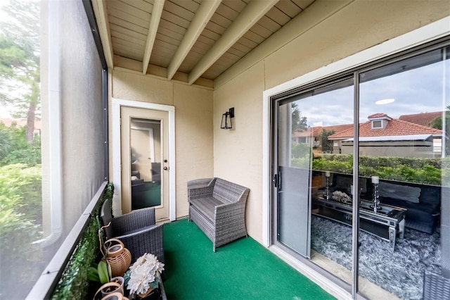 exterior space with beam ceiling and wooden ceiling