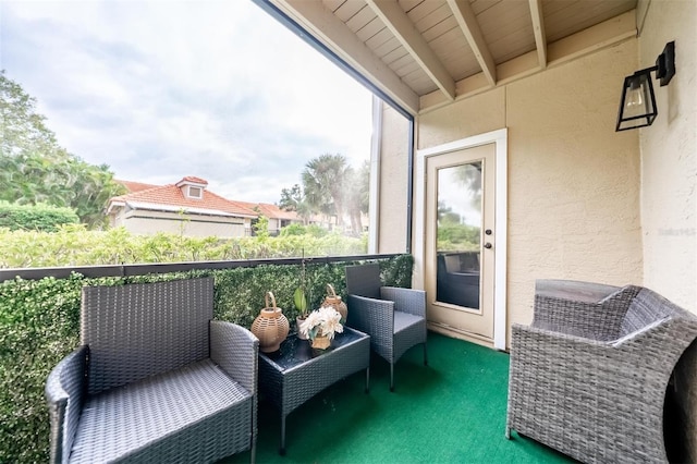 sunroom featuring beamed ceiling