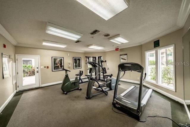 exercise room with crown molding, a textured ceiling, and dark colored carpet