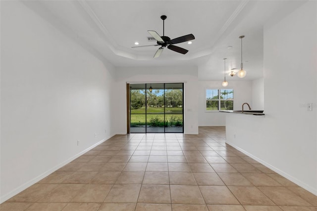 unfurnished room with sink, crown molding, light tile patterned floors, a raised ceiling, and ceiling fan