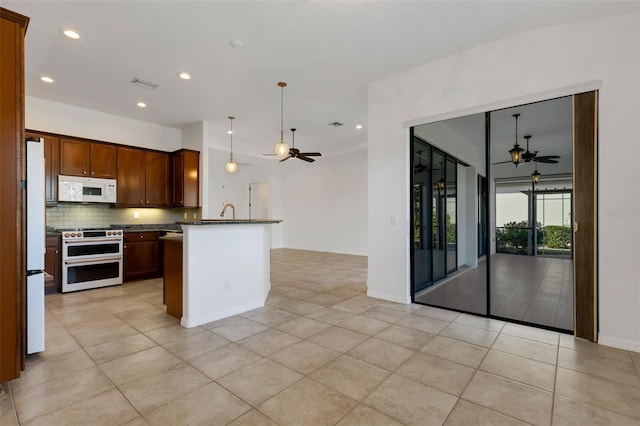 kitchen with light tile patterned floors, white appliances, ceiling fan, tasteful backsplash, and decorative light fixtures