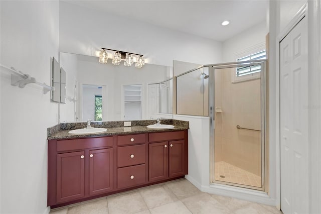 bathroom featuring vanity, tile patterned flooring, and walk in shower