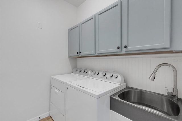 laundry room featuring cabinets, sink, and washing machine and dryer