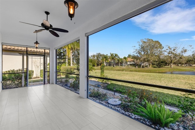 unfurnished sunroom featuring ceiling fan