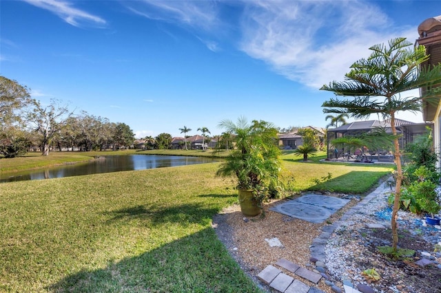 view of yard featuring a water view and a lanai