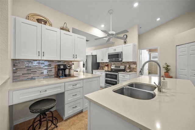 kitchen featuring appliances with stainless steel finishes, sink, and white cabinets