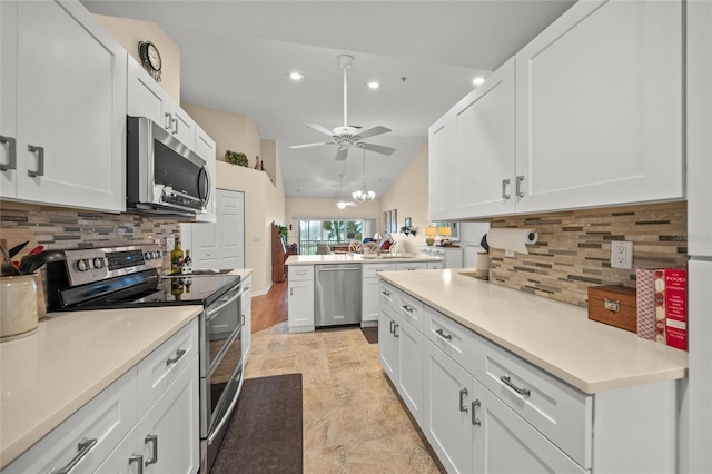 kitchen featuring white cabinetry, ceiling fan, stainless steel appliances, and kitchen peninsula