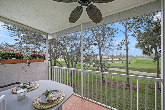 unfurnished sunroom with ceiling fan