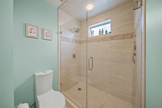 bathroom with toilet and an enclosed shower