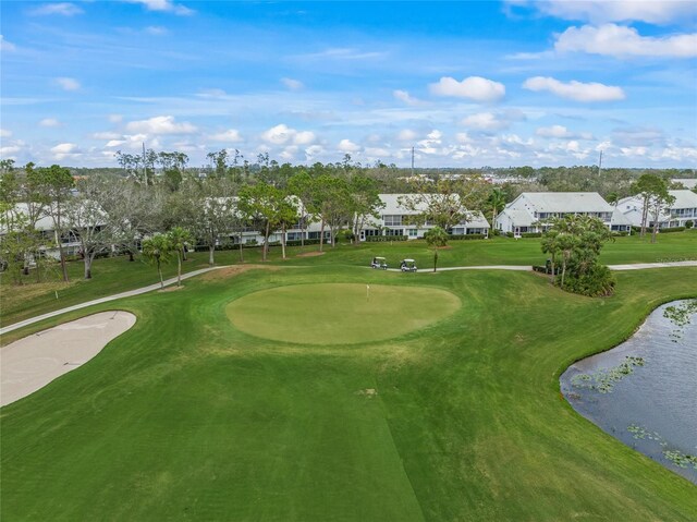 surrounding community with a residential view, view of golf course, a water view, and a yard