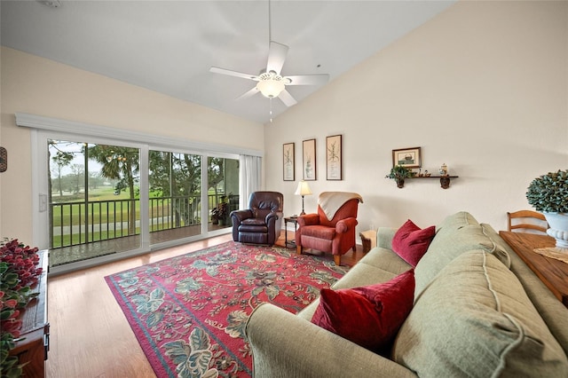 living area featuring a ceiling fan, high vaulted ceiling, and wood finished floors