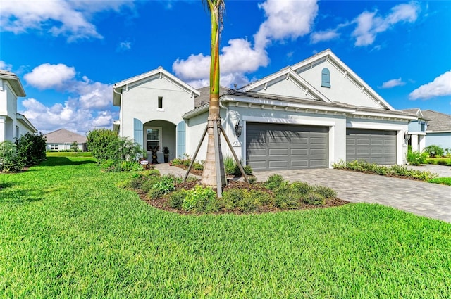 view of front of house featuring a garage and a front lawn