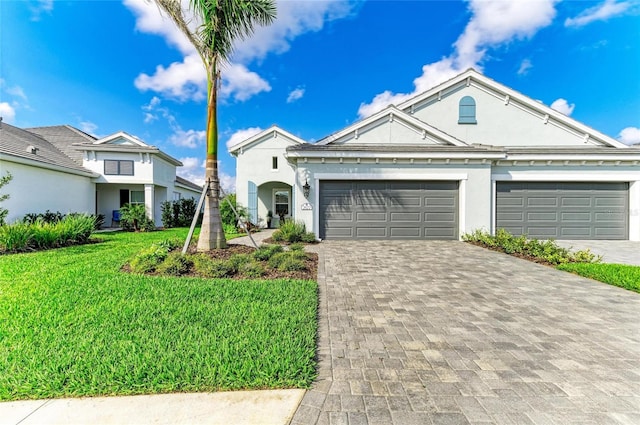 view of front of house with a garage and a front lawn