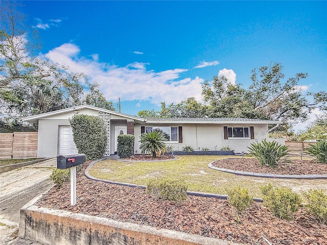 single story home with a garage and a front yard