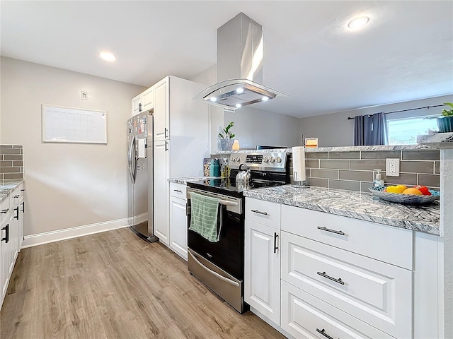 kitchen featuring appliances with stainless steel finishes, white cabinetry, light stone countertops, island exhaust hood, and light wood-type flooring