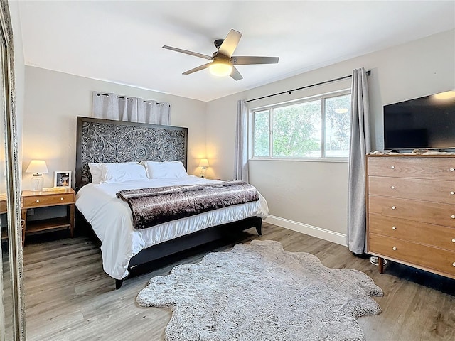 bedroom with hardwood / wood-style flooring and ceiling fan