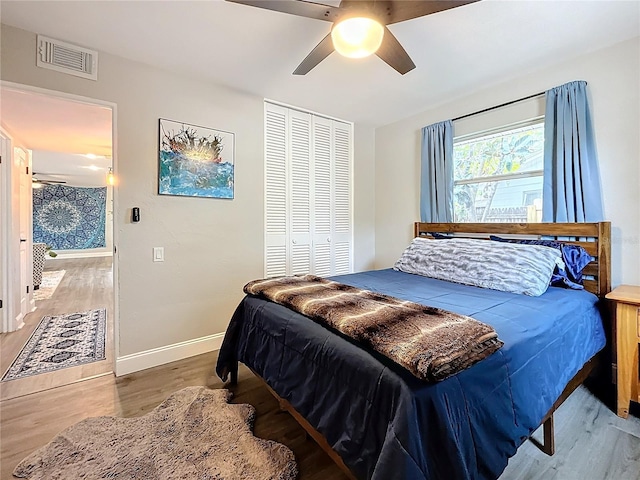 bedroom featuring wood-type flooring, ceiling fan, and a closet