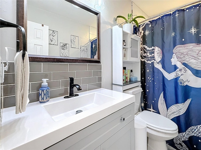 bathroom with tasteful backsplash, vanity, and toilet