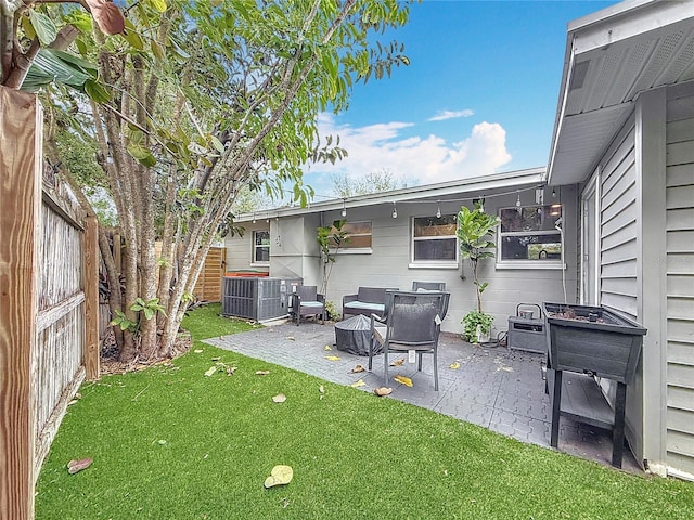 view of yard featuring central AC unit and a patio area