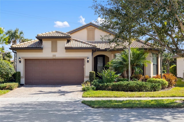 mediterranean / spanish-style home featuring a garage