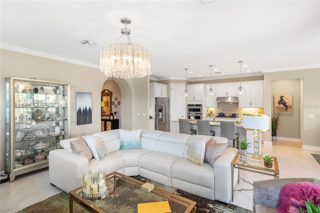 tiled living room featuring crown molding and a chandelier