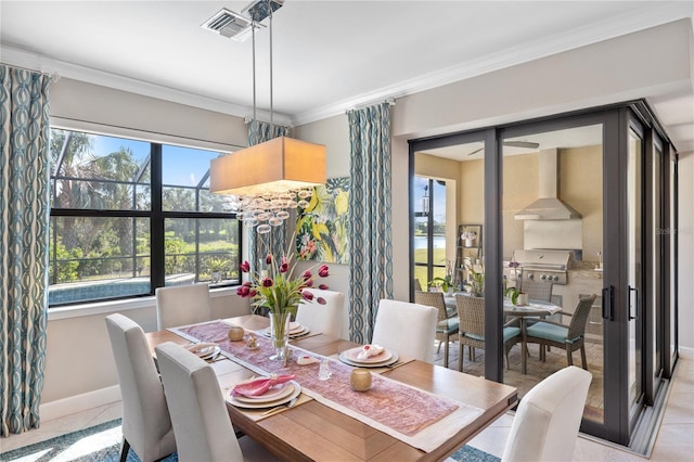 dining area featuring light tile patterned floors and crown molding