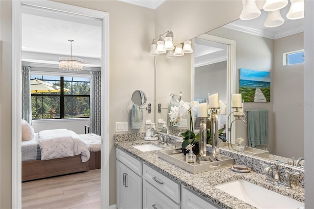 bathroom featuring vanity, hardwood / wood-style floors, and ornamental molding