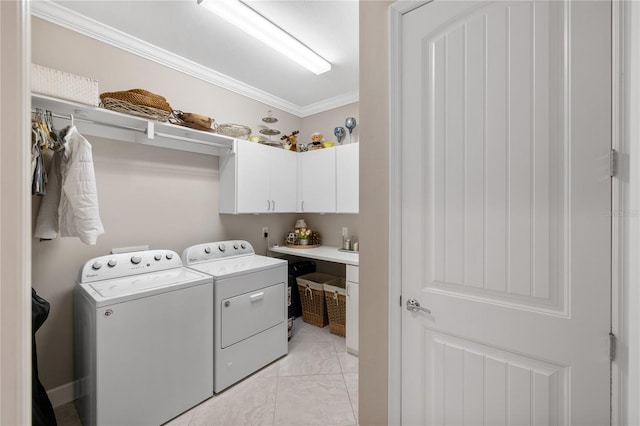 washroom with cabinets, crown molding, and washer and clothes dryer