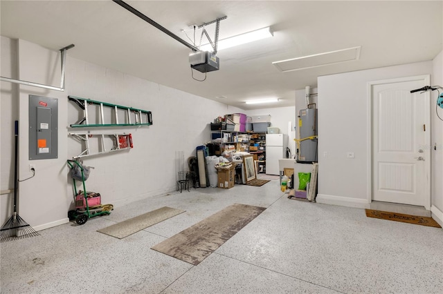 garage featuring water heater, a garage door opener, electric panel, and white fridge