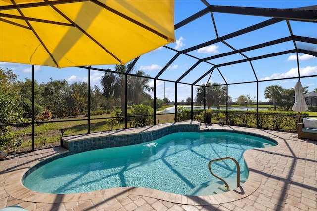 view of pool with glass enclosure and a patio area